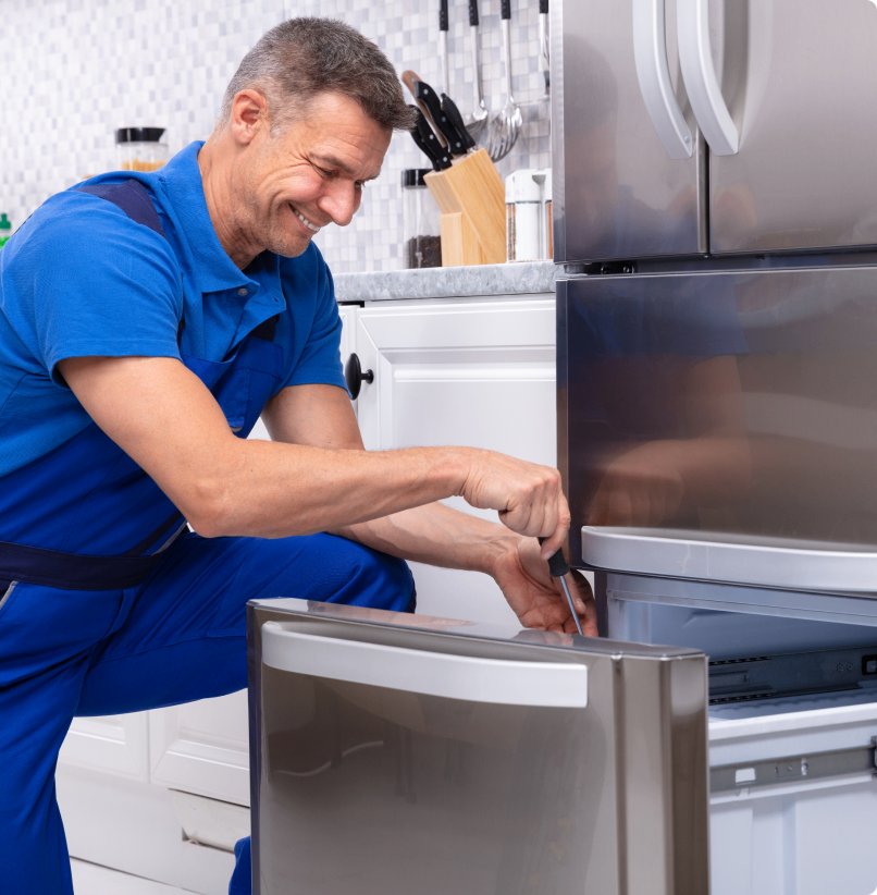 h1 08 Man repairing a kitchen refrigerator drawer.