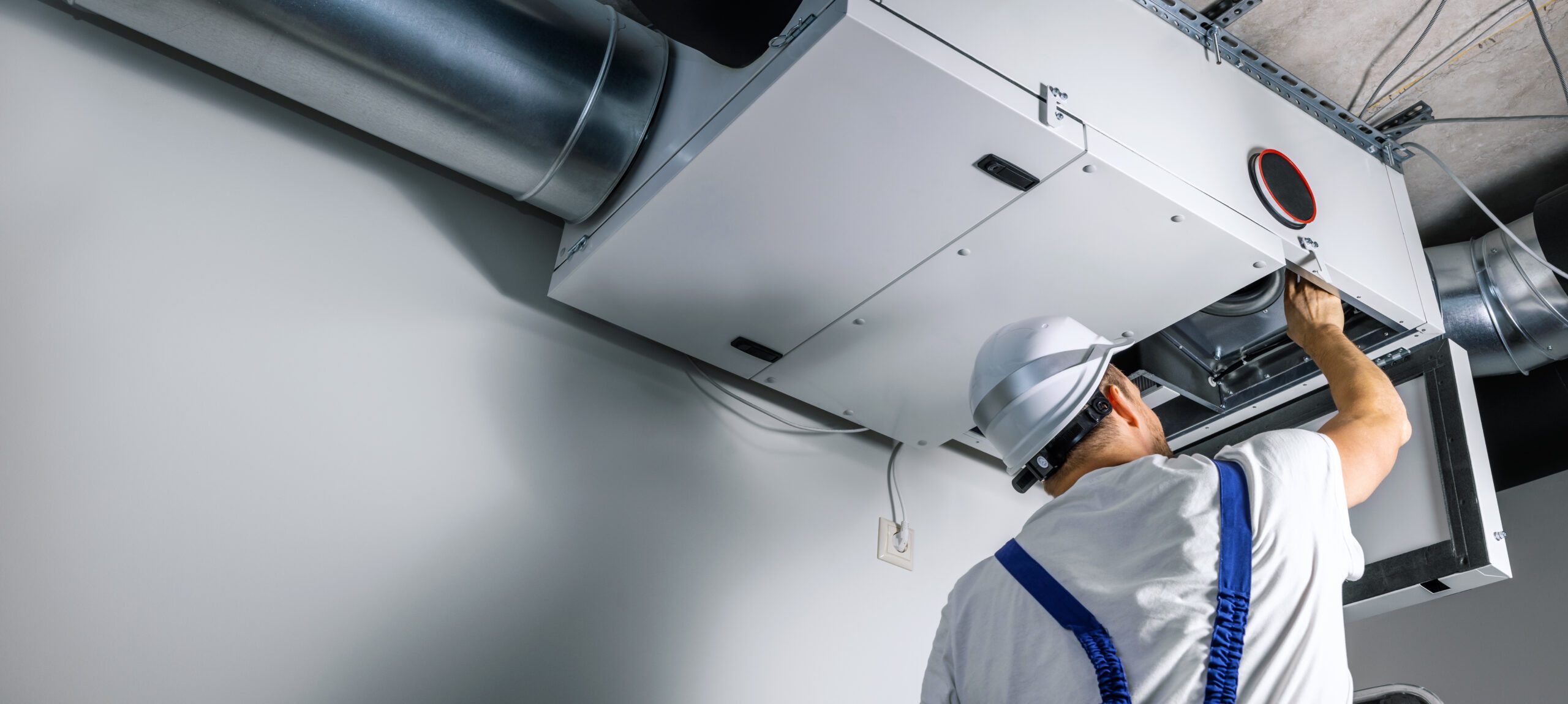 hvac engineer install heat recovery ventilation system for new house. copy space hvac engineer install heat recovery ventilation system for new house. copy space
